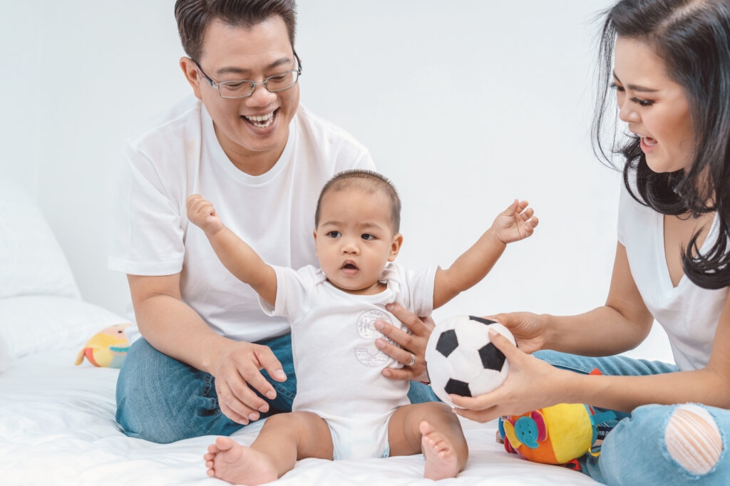 Asian Happiness family scene of boy baby with father and mother in the bedroom of house,Family Lifestyle Concept